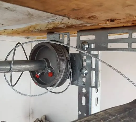 Loose garage door cable unwound from its drum