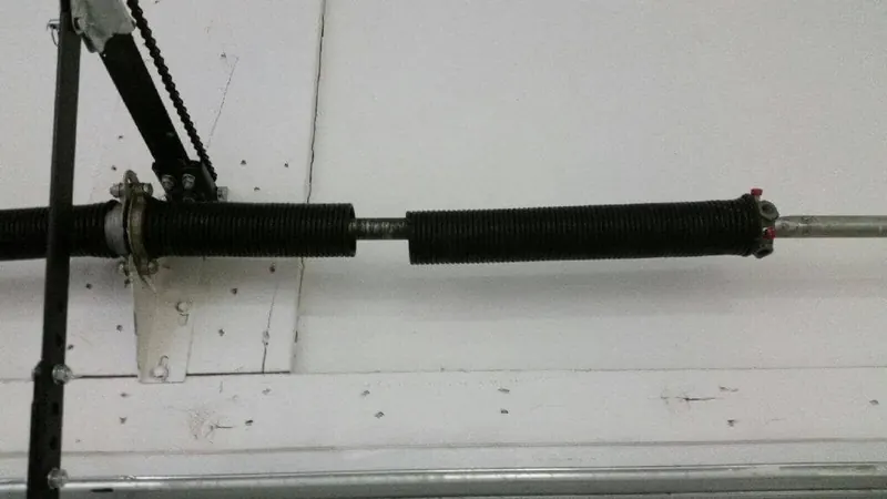Broken torsion spring with a visible gap in the coil